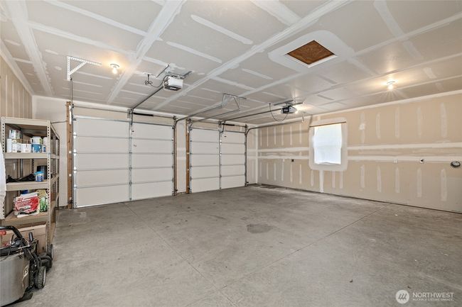 Oversized 2-car garage with ample storage space and a separate workshop area. Perfect for vehicles, tools, or outdoor gear. | Image 28