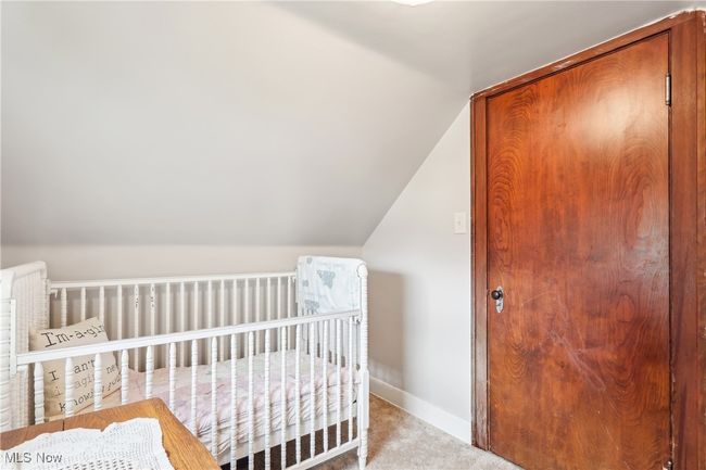 Carpeted bedroom featuring lofted ceiling, a closet, and baseboards | Image 22