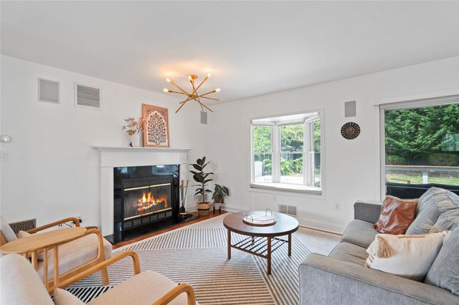 Dining space with a decorative wall, wainscoting, light wood-type flooring, recessed lighting, and ceiling fan | Image 10