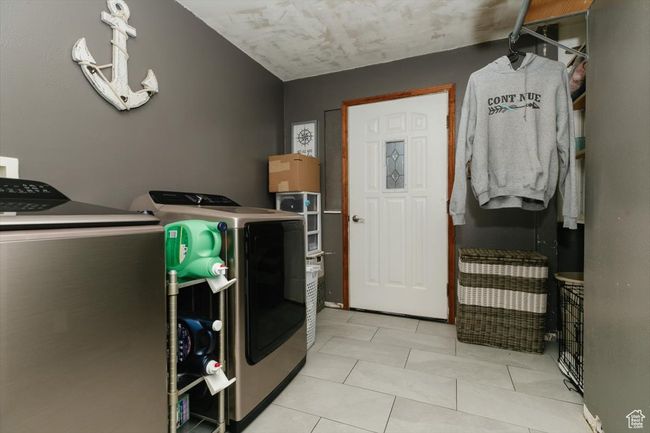 Laundry room with washing machine and dryer, laundry area, and light tile patterned flooring | Image 29