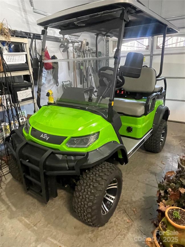Golf cart located in 3rd bay of garage is negotiable. Perfect to run around the neighborhood or take down to the lake on the gravel path. | Image 39