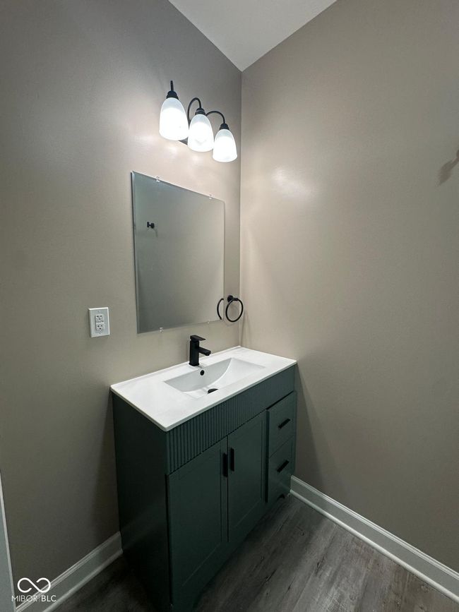 Unit 1 - Master bathroom with vanity and wood finished floors | Image 11