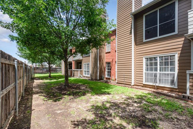 View of fenced backyard | Image 26