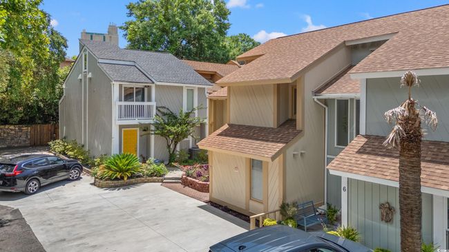 View of front of property featuring a shingled roof and a chimney | Image 34