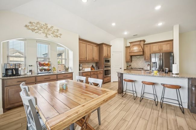 Dining space featuring light wood-style flooring, recessed lighting, and vaulted ceiling | Image 12