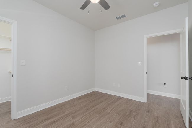 Empty room featuring visible vents, baseboards, wood finished floors, and ceiling fan | Image 28