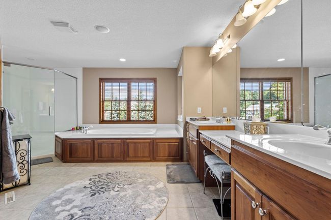 Primary spa bath features a separate tub and shower and a water closet | Image 31