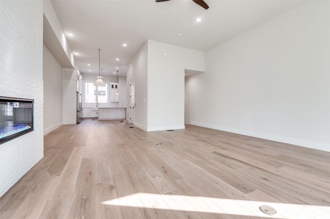 Living towards kitchen fireplace, recessed lighting, light wood-type flooring, and baseboards | Image 6