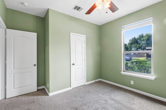 Unfurnished bedroom with carpet flooring and ceiling fan | Image 24