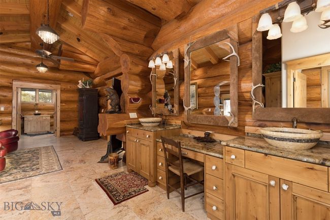 Primary bathroom featuring beamed wood ceiling and vanity. | Image 21