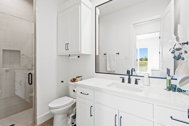 Bathroom featuring a shower stall and vanity | Image 17