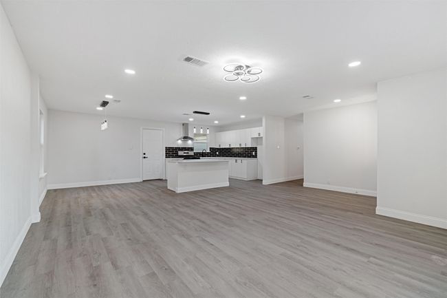 Unfurnished living room featuring light hardwood / wood-style flooring | Image 12