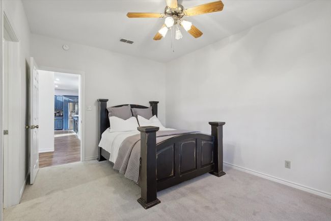 Bedroom 1st floor featuring light carpet and ceiling fan | Image 23
