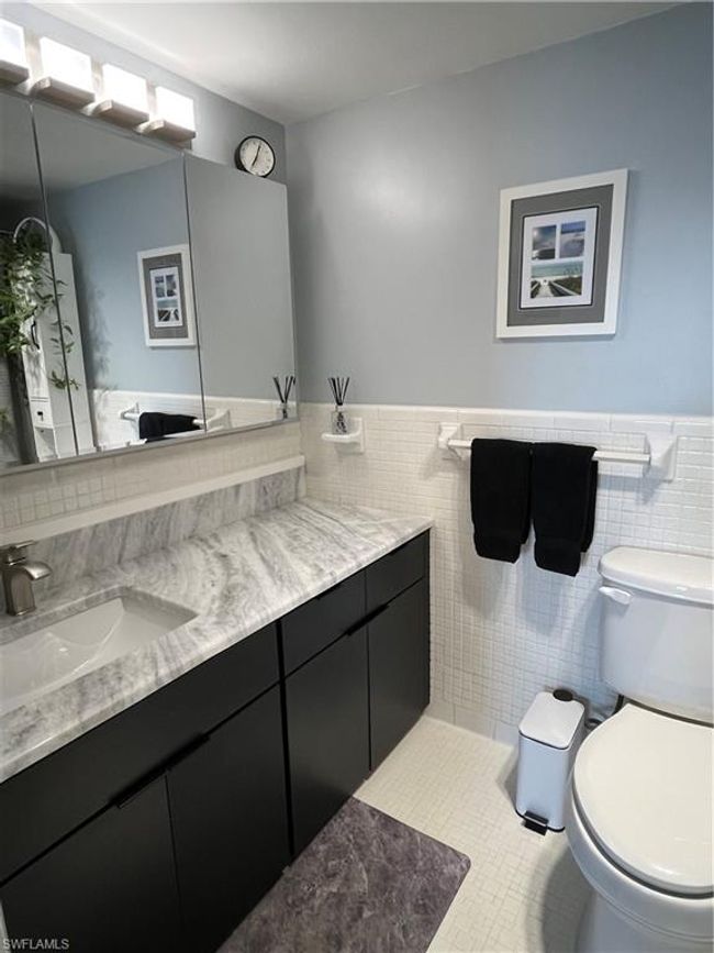 Bathroom featuring vanity, tile walls, and a wainscoted wall | Image 12