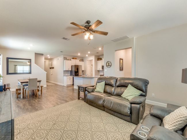 Living room with light wood finished floors, a ceiling fan, and recessed lighting | Image 7