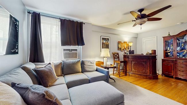 Living room with hardwood / wood-style flooring, ceiling fan, and cooling unit | Image 5