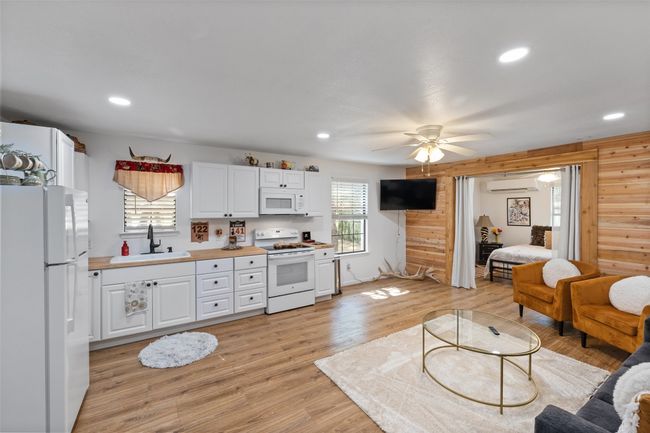 Kitchen featuring white cabinetry, a sink, white appliances, and recessed lighting | Image 27