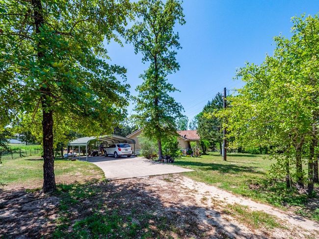 View from front gate showing carport and driveway | Image 30