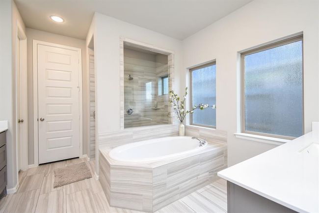 Soaking tub and upgraded oversized shower make this primary bath something to enjoy as your own at home spa feel experience | Image 23