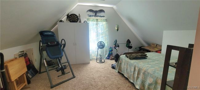 Bedroom featuring lofted ceiling and carpet floors | Image 11