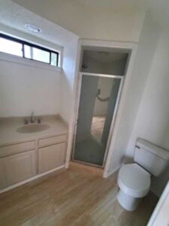 Bathroom with a shower stall, wood finished floors, and vanity | Image 21