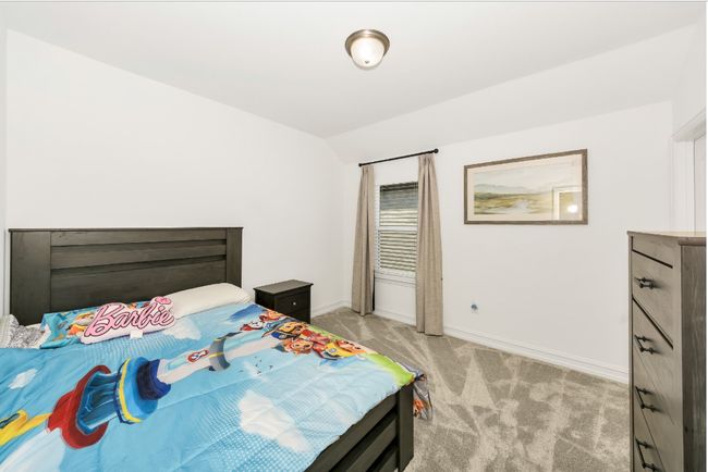 Bedroom featuring light carpet, vaulted ceiling, and baseboards | Image 24