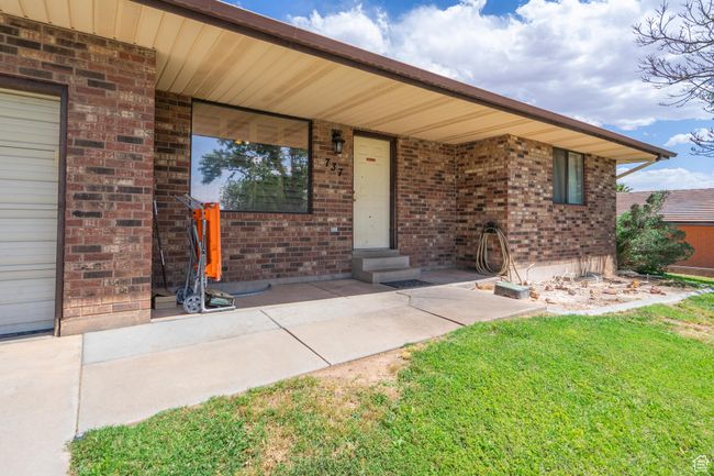 Entrance to property with a yard and brick siding | Image 13