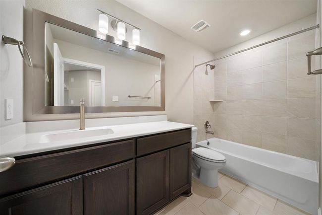 3rd Full bathroom located on the 2nd floor featuring a tub/shower combo and framed mirror. | Image 26