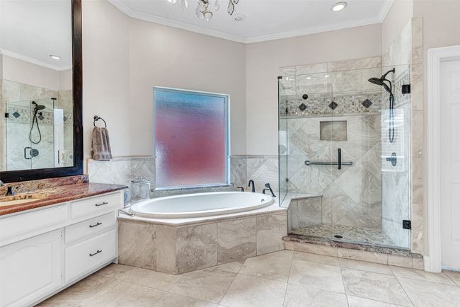 Who wouldn't love to relax after a long day in this deep jetted soaking tub, or luxuriate in the oversized tiled shower with removable spray option? | Image 25