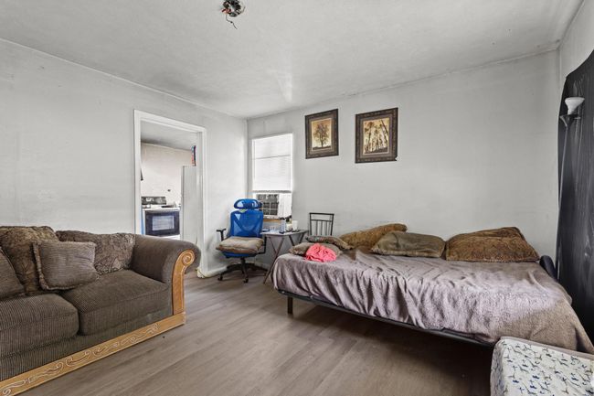 Living room featuring wood finished floors and cooling unit | Image 4