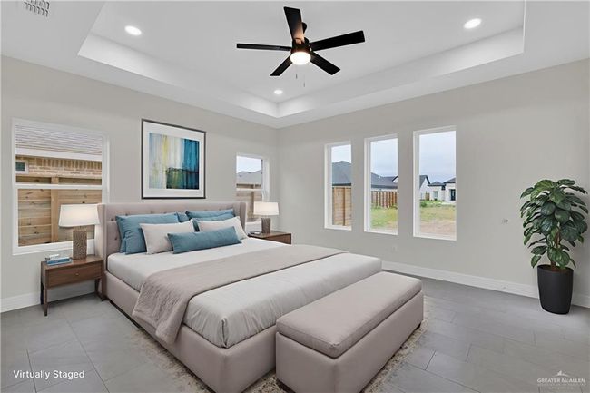 Bedroom with a tray ceiling, recessed lighting, baseboards, light tile patterned floors, and ceiling fan | Image 12