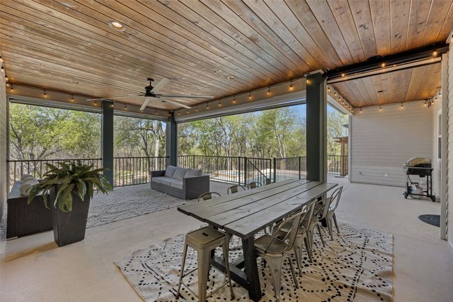 Main outdoor covered patio overlooking the tranquil backyard oasis. | Image 33
