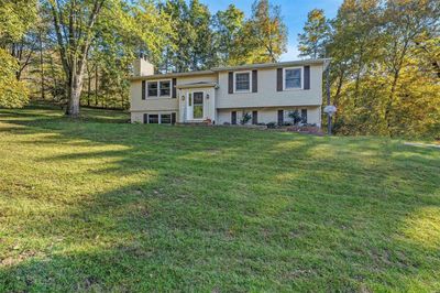 Bi-level home featuring a front yard | Image 1