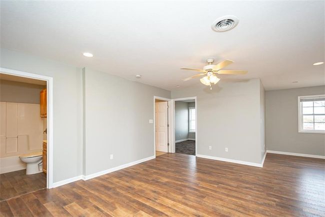 Empty room with visible vents, baseboards, ceiling fan, recessed lighting, and wood finished floors | Image 5