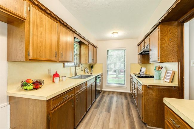 Spacious kitchen with gas range, gas oven w/ warmer, farm style stainless sink and an abundance of counter & cabinets. LVP throughout the living spaces. | Image 15
