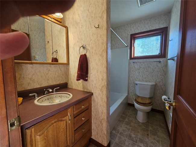 The family bathroom boasts a tub shower. | Image 21