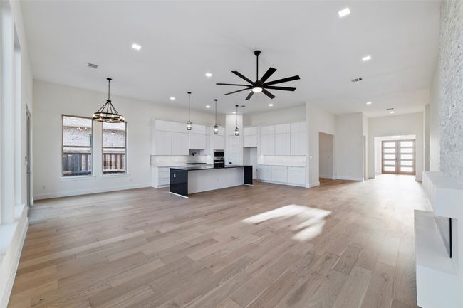 Kitchen featuring white cabinets, visible vents, light wood-style flooring, recessed lighting, and open floor plan | Image 8