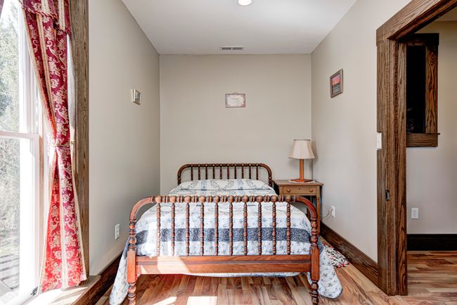 bedroom with wood finished floors, baseboards, and visible vents | Image 46