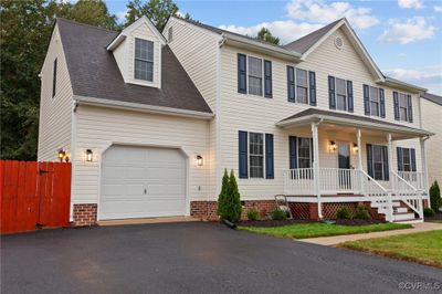 View of front of home featuring a garage and covered porch | Image 2