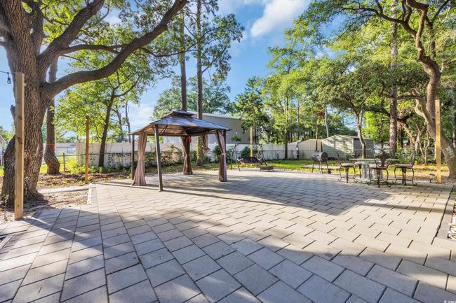 Fenced backyard with a gazebo, a patio area, and outdoor dining space | Image 24