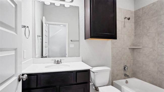 Full bathroom featuring toilet, shower / bathtub combination, and vanity | Image 10