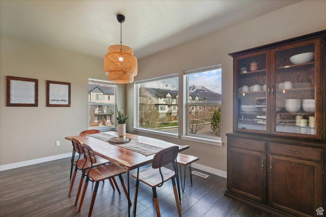 Dining area featuring baseboards and dark wood-type flooring | Image 15
