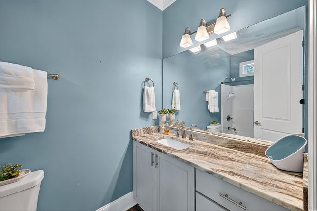 Bathroom featuring vanity, crown molding, and a shower | Image 25