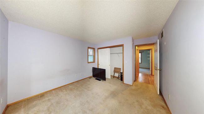 Unfurnished bedroom with baseboards, visible vents, a closet, a textured ceiling, and light colored carpet | Image 23