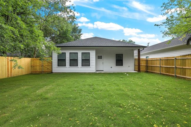 Rear view of house featuring a fenced backyard and roof with shingles | Image 14