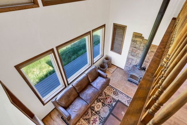 Living room with a high ceiling and a wood stove | Image 32