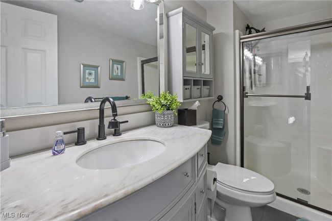 Full bath with toilet, a stall shower, tile patterned flooring, and vanity | Image 18