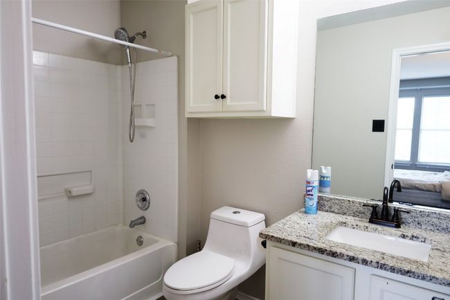 Full bath featuring toilet, vanity, and tub / shower combination | Image 10