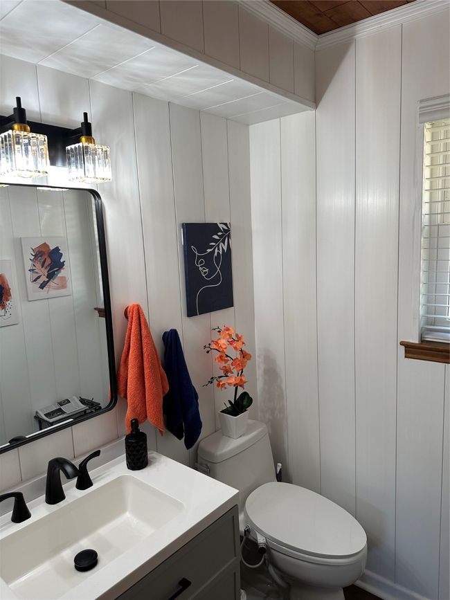 Half bath with toilet, vanity, and a decorative wall | Image 6