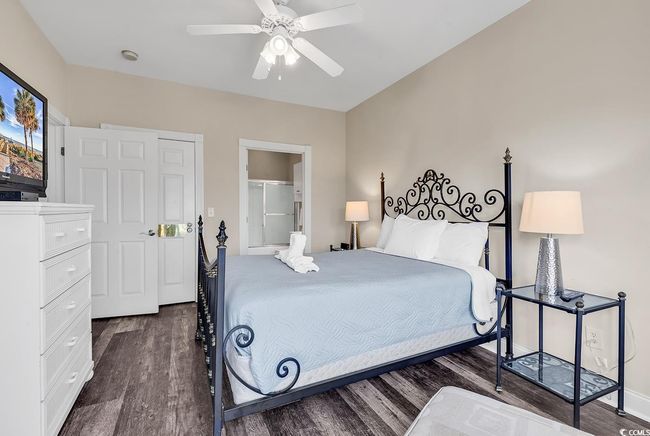 Bedroom with dark wood-type flooring and ceiling fan | Image 19
